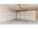 Unfinished garage with concrete floor, drywall, and paneled door at 12243 Belfry Dr, Noblesville, IN 46060