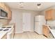 Functional kitchen with wooden cabinets, white appliances, and light countertops at 12243 Belfry Dr, Noblesville, IN 46060