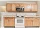 Kitchen featuring stainless steel microwave, white electric range, and light wood cabinetry at 12243 Belfry Dr, Noblesville, IN 46060