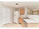 Well-lit kitchen with modern appliances, bright white refrigerator, and wood cabinetry at 12243 Belfry Dr, Noblesville, IN 46060