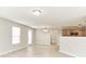 Bright living room with wood-look floors, neutral walls, and access to an outdoor patio at 12243 Belfry Dr, Noblesville, IN 46060