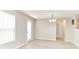 Bright living room featuring wood-look floors, neutral walls, and a modern chandelier at 12243 Belfry Dr, Noblesville, IN 46060