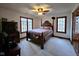 Bedroom with a four-poster bed, carpeted floors, two windows, and traditional decor at 1285 W Judson Ln, Mooresville, IN 46158