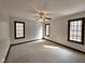 Empty bedroom boasting carpeted floors, three windows, and neutral walls at 1285 W Judson Ln, Mooresville, IN 46158
