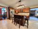 Kitchen with dark wood cabinets, stainless steel appliances, island with seating, and open floor plan at 1285 W Judson Ln, Mooresville, IN 46158