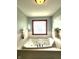 Relax in this soaking tub with glass block window and neutral wall color at 1285 W Judson Ln, Mooresville, IN 46158