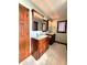 This main bathroom offers double sinks, wood cabinets, tile floors, and wood trim at 1285 W Judson Ln, Mooresville, IN 46158