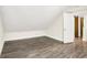 Finished attic space featuring wood floors, fresh paint, and a sliding door to a closet at 1304 N Tuxedo St, Indianapolis, IN 46201