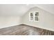 Finished attic with hardwood floors, fresh paint, and two windows at 1304 N Tuxedo St, Indianapolis, IN 46201