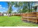 Expansive backyard with a wood deck, mature trees, and lush green lawn, perfect for outdoor activities and relaxation at 1304 N Tuxedo St, Indianapolis, IN 46201