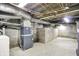 Unfinished basement featuring cement walls and floors with exposed utilities at 1304 N Tuxedo St, Indianapolis, IN 46201