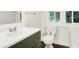 Stylish bathroom featuring an olive vanity with a bright white countertop and modern fixtures at 1304 N Tuxedo St, Indianapolis, IN 46201