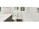 Bright bathroom with a tub, toilet, and a vanity at 1304 N Tuxedo St, Indianapolis, IN 46201