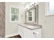 Bright bathroom featuring a double sink vanity, a modern toilet, and a window at 1304 N Tuxedo St, Indianapolis, IN 46201