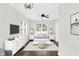 Stylishly staged bedroom with white furniture, neutral tones, and dark wood floors at 1304 N Tuxedo St, Indianapolis, IN 46201