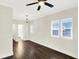 Spacious bedroom with ample natural light, ceiling fan, and hardwood flooring at 1304 N Tuxedo St, Indianapolis, IN 46201