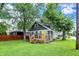 Charming home with a well-maintained lawn, a wooden deck, and a bright yellow front door for a welcoming curb appeal at 1304 N Tuxedo St, Indianapolis, IN 46201