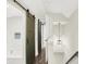 Hallway with sliding barn doors leading to a stylish bathroom at 1304 N Tuxedo St, Indianapolis, IN 46201