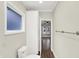 Bathroom hallway with a linen closet, a toilet, and access to the living room at 1304 N Tuxedo St, Indianapolis, IN 46201