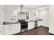 Well-lit kitchen featuring stainless steel appliances, white subway tile backsplash, and dark countertops at 1304 N Tuxedo St, Indianapolis, IN 46201