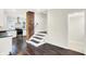 Charming kitchen with modern stainless steel appliances, white cabinets, and unique brick column at 1304 N Tuxedo St, Indianapolis, IN 46201