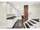 Bright, updated kitchen showcasing white cabinetry, stainless steel appliances, and a brick column accent at 1304 N Tuxedo St, Indianapolis, IN 46201