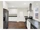 Modern kitchen featuring stainless steel refrigerator, sleek countertops and ample white cabinets at 1304 N Tuxedo St, Indianapolis, IN 46201