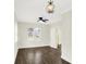 Bright living room featuring hardwood floors, a ceiling fan, and an ornate chandelier at 1304 N Tuxedo St, Indianapolis, IN 46201