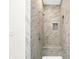Modern shower with marble tile, a built-in seat, and a recessed niche at 1304 N Tuxedo St, Indianapolis, IN 46201