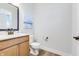 Cozy half bathroom with wood vanity, modern fixtures, and neutral decor at 13383 Vickery Ridge Dr, Fishers, IN 46037