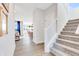 Hallway with stairway, light walls, and views into a living room and dining space at 13383 Vickery Ridge Dr, Fishers, IN 46037