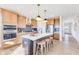 Bright kitchen features an island with seating, stainless steel appliances, and pendant lighting at 13383 Vickery Ridge Dr, Fishers, IN 46037
