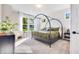Relaxing main bedroom features natural light, a stylish canopy bed, and view of the yard at 13383 Vickery Ridge Dr, Fishers, IN 46037