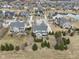 A high-angle aerial shot displays a housing community with ponds, manicured lawns, and several houses at 14466 Integrity Ct, Carmel, IN 46033
