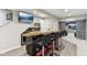 Finished basement bar with a live-edge countertop, mini fridge, and barstools at 14466 Integrity Ct, Carmel, IN 46033