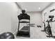 Finished basement gym features modern workout equipment and neutral gray walls with recessed lighting at 14466 Integrity Ct, Carmel, IN 46033