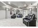 Finished basement with black leather recliners, blue blanket, tray ceiling, and recessed lighting at 14466 Integrity Ct, Carmel, IN 46033