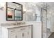 Bathroom with granite counters, undermount sink, gray tile, sliding glass door shower, and modern lighting at 14466 Integrity Ct, Carmel, IN 46033
