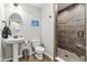 Hall bathroom features a pedestal sink, tile flooring, plus a large tiled shower with glass door at 14466 Integrity Ct, Carmel, IN 46033
