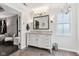 Bright bathroom with granite counters, white cabinets, a large mirror, and modern lighting at 14466 Integrity Ct, Carmel, IN 46033