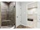 Hall bathroom with a corner shower with tile surround, glass door, and tiled floor at 14466 Integrity Ct, Carmel, IN 46033