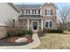 The home's inviting entrance is framed by elegant stone accents, offering a warm welcome to visitors at 14466 Integrity Ct, Carmel, IN 46033