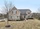 Stunning two-story home with a stone and siding exterior, complemented by mature trees and landscaping at 14466 Integrity Ct, Carmel, IN 46033