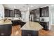 Kitchen featuring a granite countertop island, stainless appliances, and dark wood cabinets with white subway tile back splash at 14466 Integrity Ct, Carmel, IN 46033
