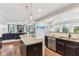 Bright kitchen with dark cabinets, stainless steel appliances, granite countertops, and an island overlooking the living room at 14466 Integrity Ct, Carmel, IN 46033
