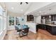 Bright kitchen features a breakfast nook with large window and dark cabinetry with stainless steel appliances at 14466 Integrity Ct, Carmel, IN 46033