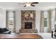 Cozy living room featuring a stone fireplace, creating a warm and inviting atmosphere for Gathering and friends at 14466 Integrity Ct, Carmel, IN 46033