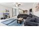 A stylish living room with large sectional sofa, showcasing the open-concept design flowing to the kitchen area at 14466 Integrity Ct, Carmel, IN 46033