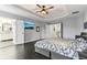 Main bedroom with trey ceiling, hardwood floors, tv, and adjoining bath at 14466 Integrity Ct, Carmel, IN 46033