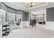 Bright, large room with tray ceilings, large windows and connecting space to a home office at 14466 Integrity Ct, Carmel, IN 46033
